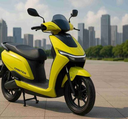 TVS Orbiter electric scooter in Neon Sunburst yellow parked outdoors, showcasing modern design, LED headlamp, and commuter-friendly features for Indian riders